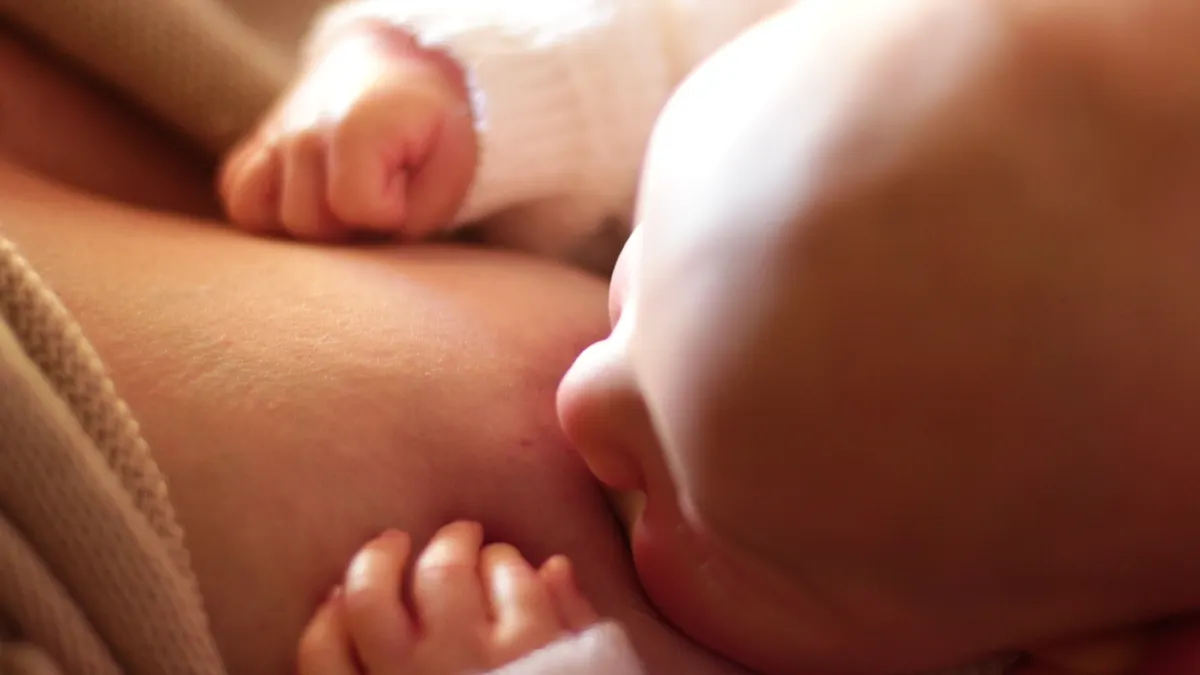 Extreme close-up of newborn latched to breast