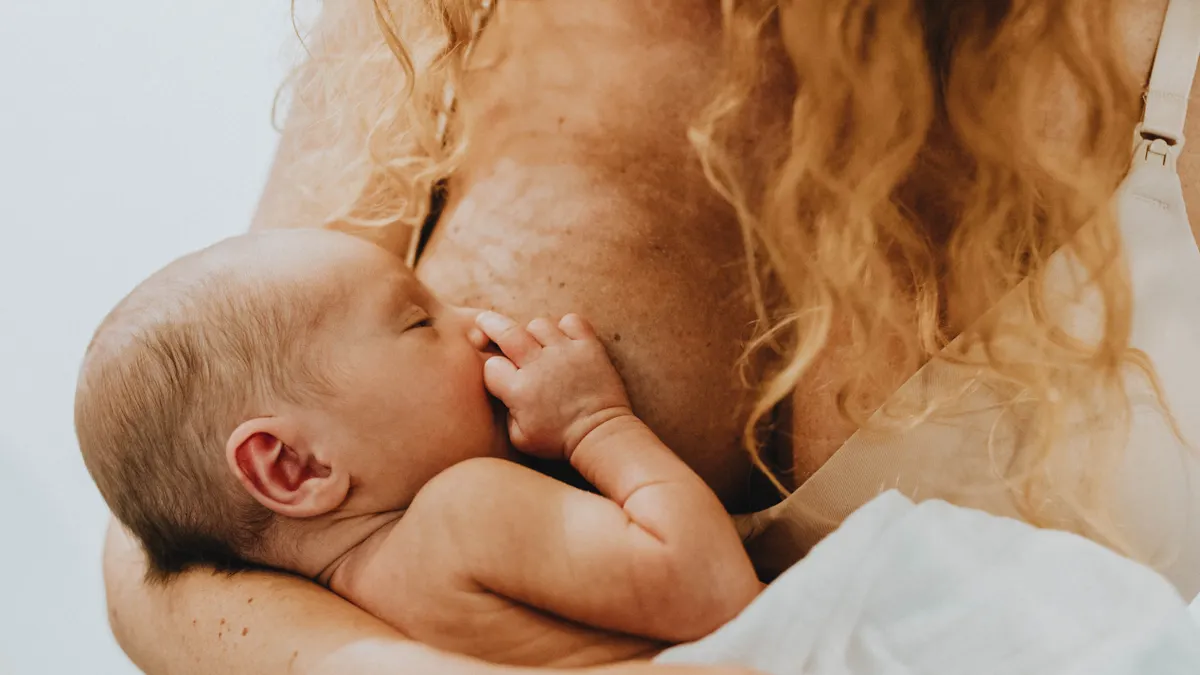 Mother breastfeeding a newborn baby