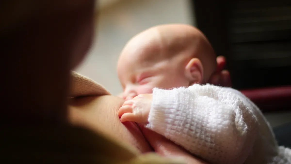 Newborn baby nursing at the breast