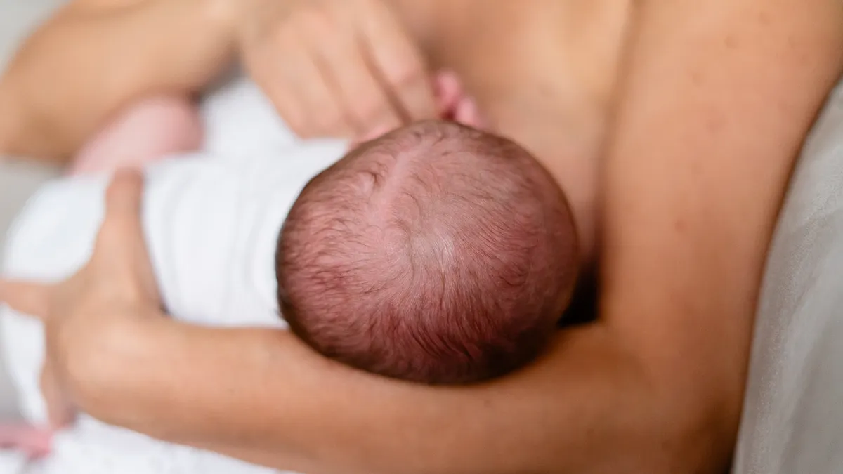 Close-up of a baby nursing at the breast