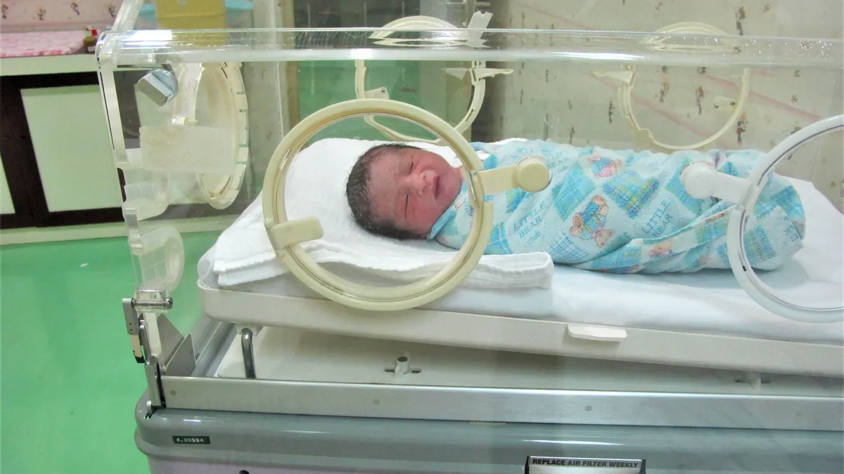 Premature baby lying in an incubator